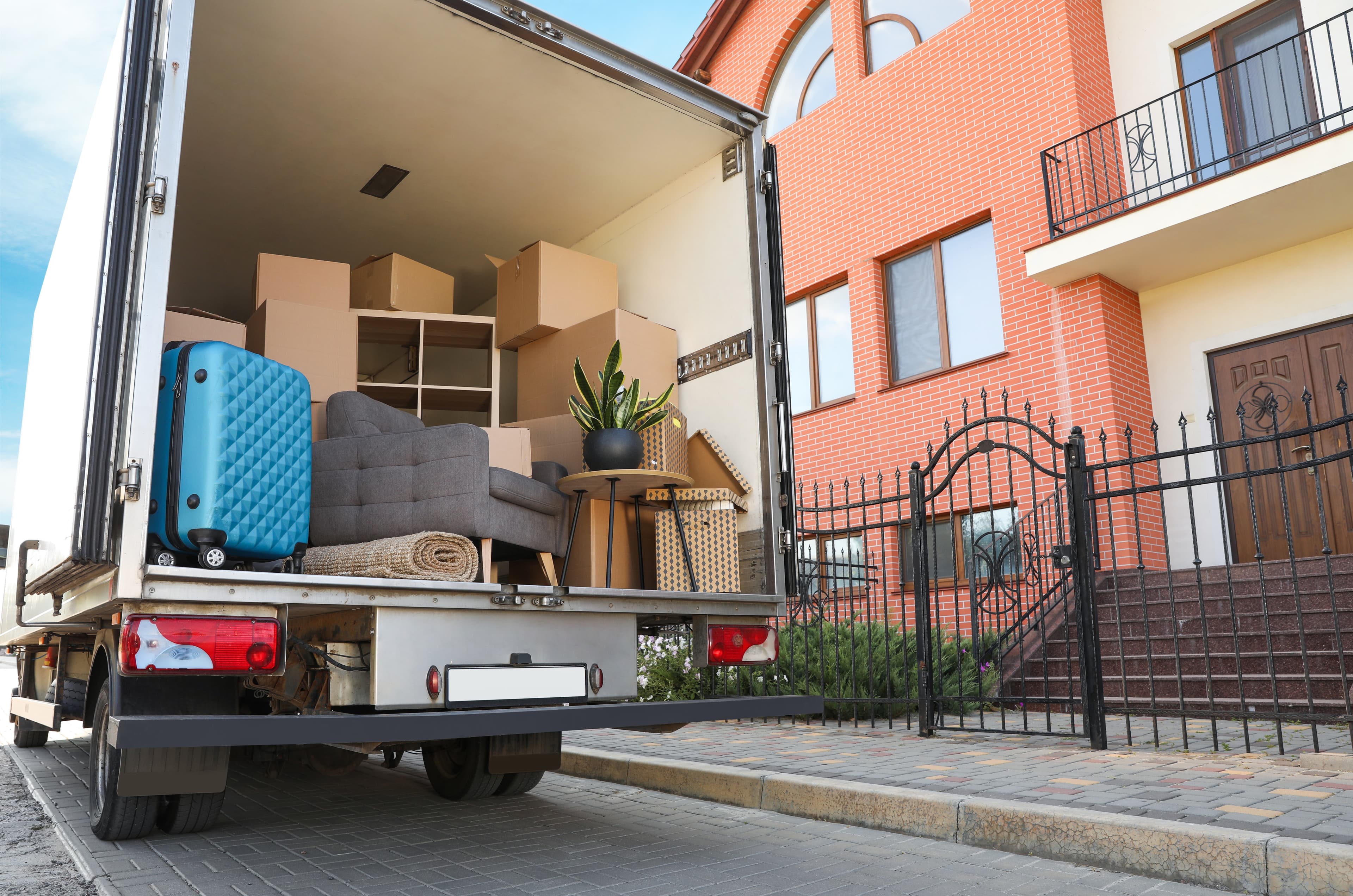 Moving truck loaded in front of a house